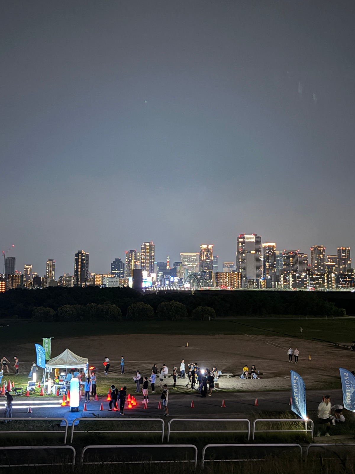Goal area of Yodogawa Night Marathon, with Osaka's Umeda skyline across the river.