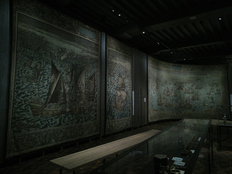 Inside hte museum, beautiful tapestries depicting sea battles.
