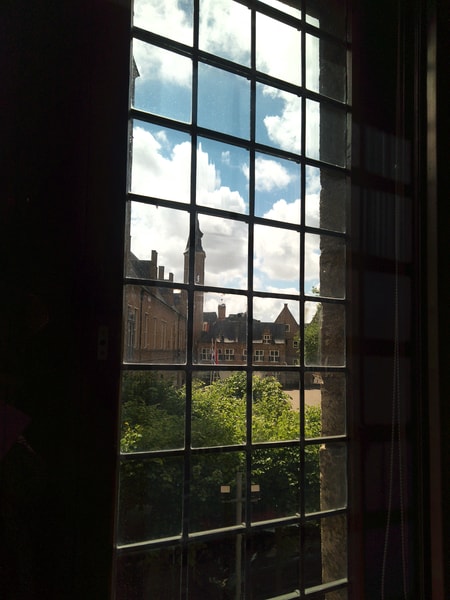 a view through one of the magnificent windows in the museum, with a view of the courtyard.
